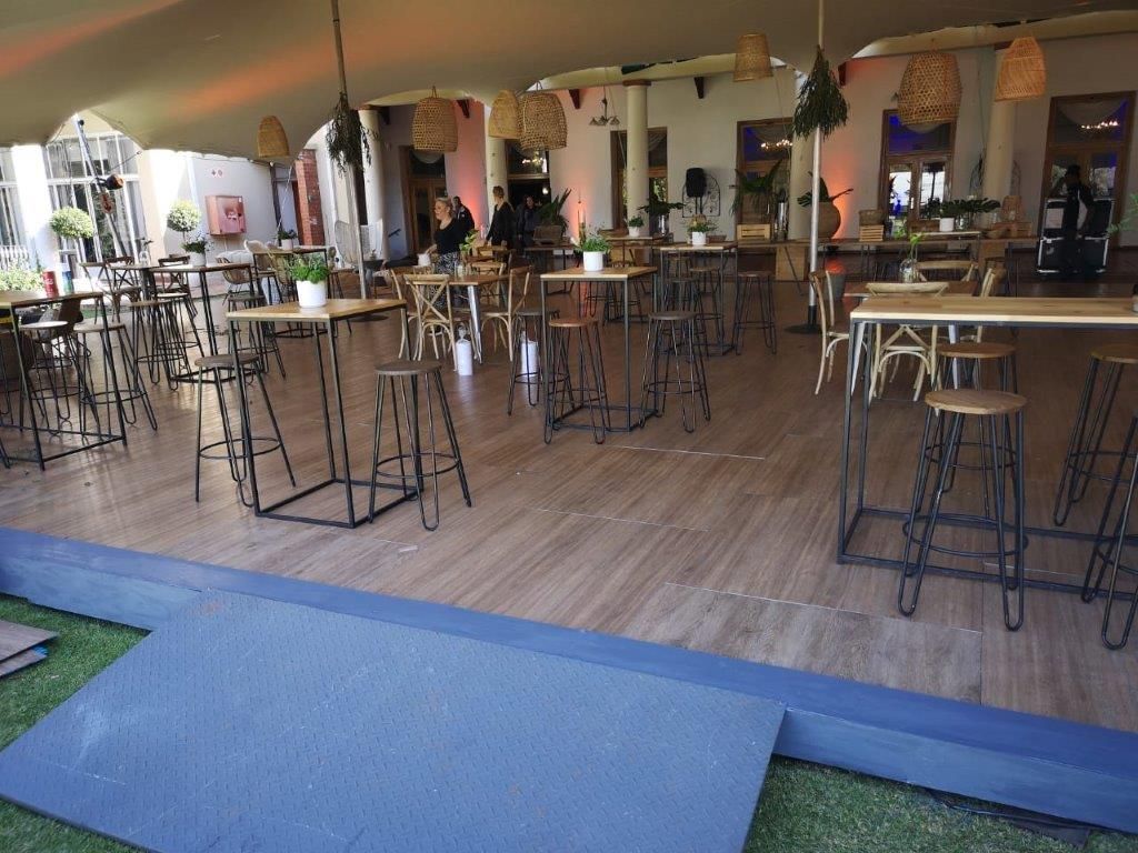 Event flooring set up for a gathering under a stretch tent