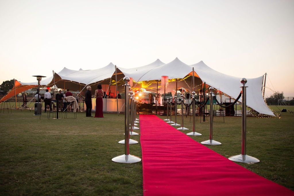 Large stretch tent with red carpet entrance at an event.