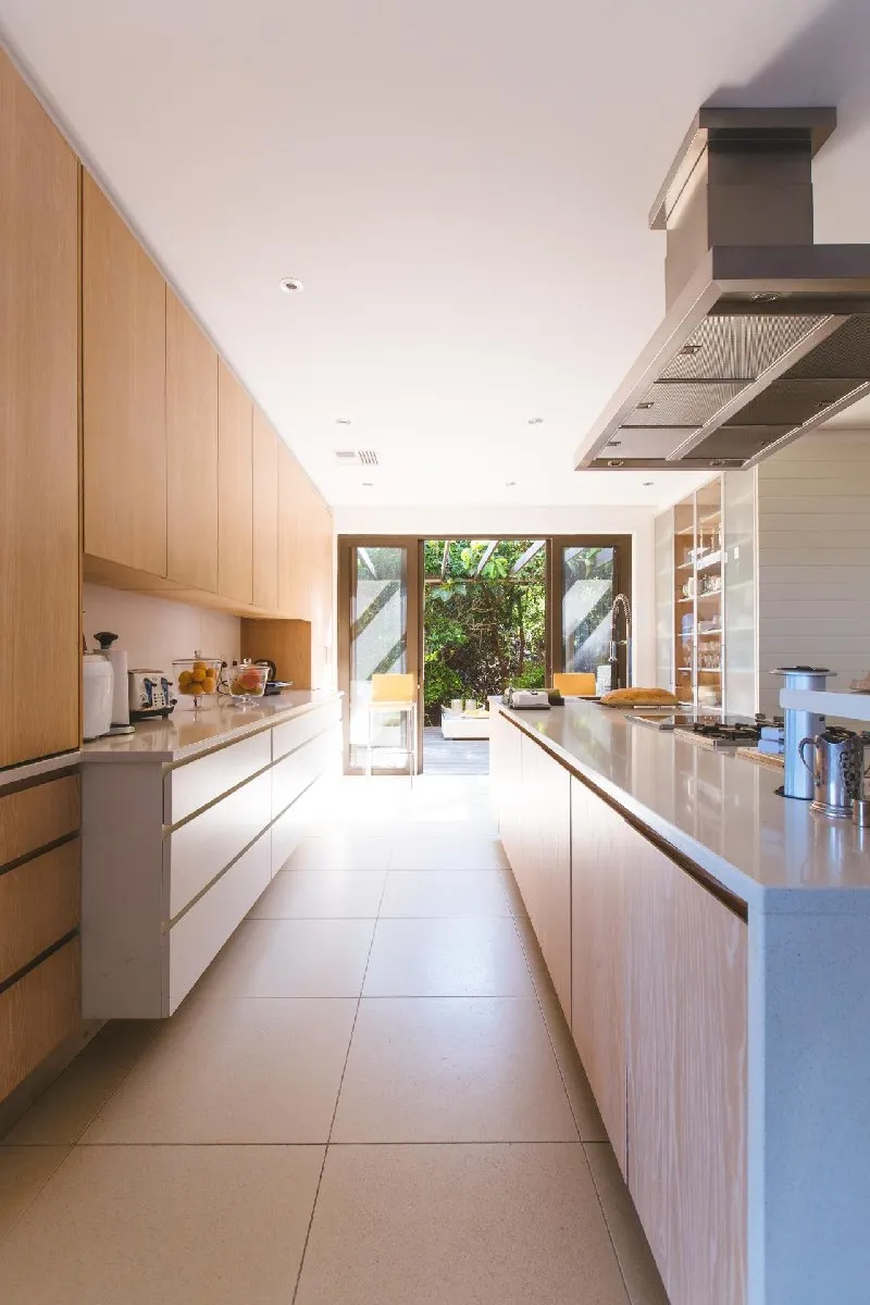 Modern kitchen with light wood cabinets and open layout