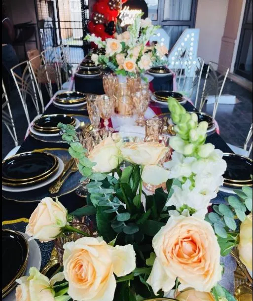 Elegantly decorated table with flowers and ornate tableware.