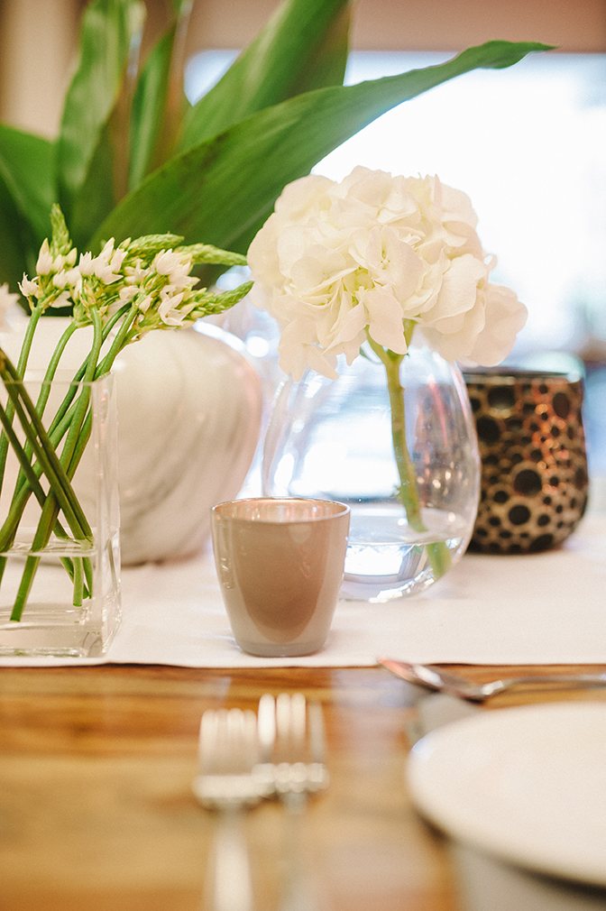 Table centerpiece with white flowers and decorative vases