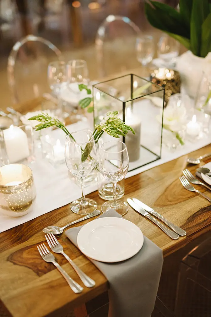 A beautifully arranged table setting with glassware and candles