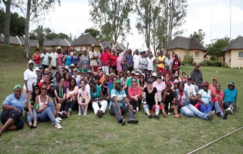 Large group of people gathered for a team building event outdoors