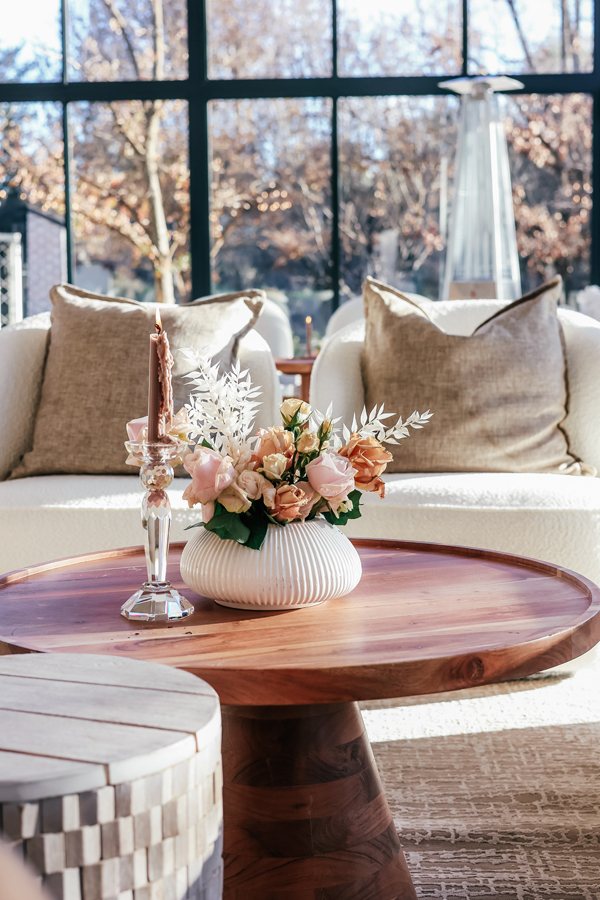 A lounge setup with floral centerpiece and cozy seating