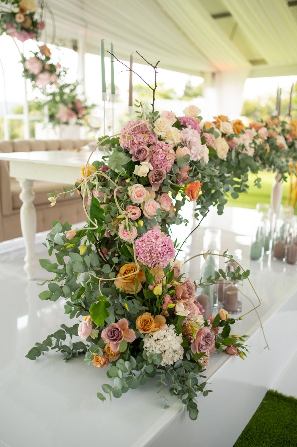 Floral centerpiece with various flowers and greenery