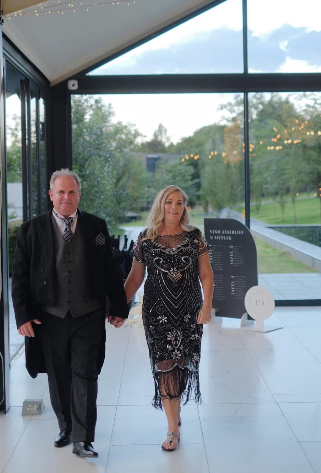 Couple walking together at a stylish event venue.