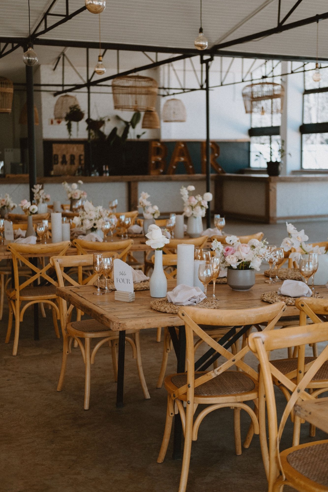 Event tables with floral centerpieces and chairs in a stylish venue