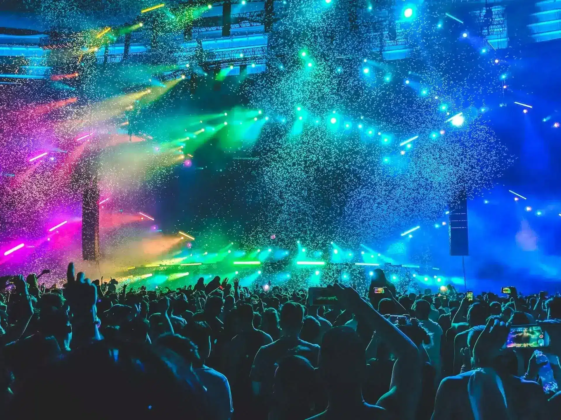Crowd enjoying a vibrant lighting setup at an event.