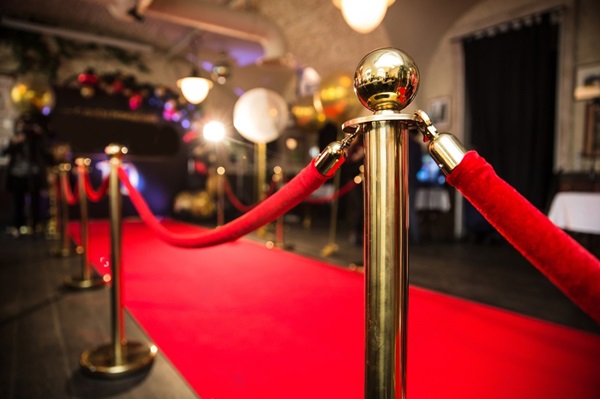 Red carpet entrance with gold stanchions and red ropes