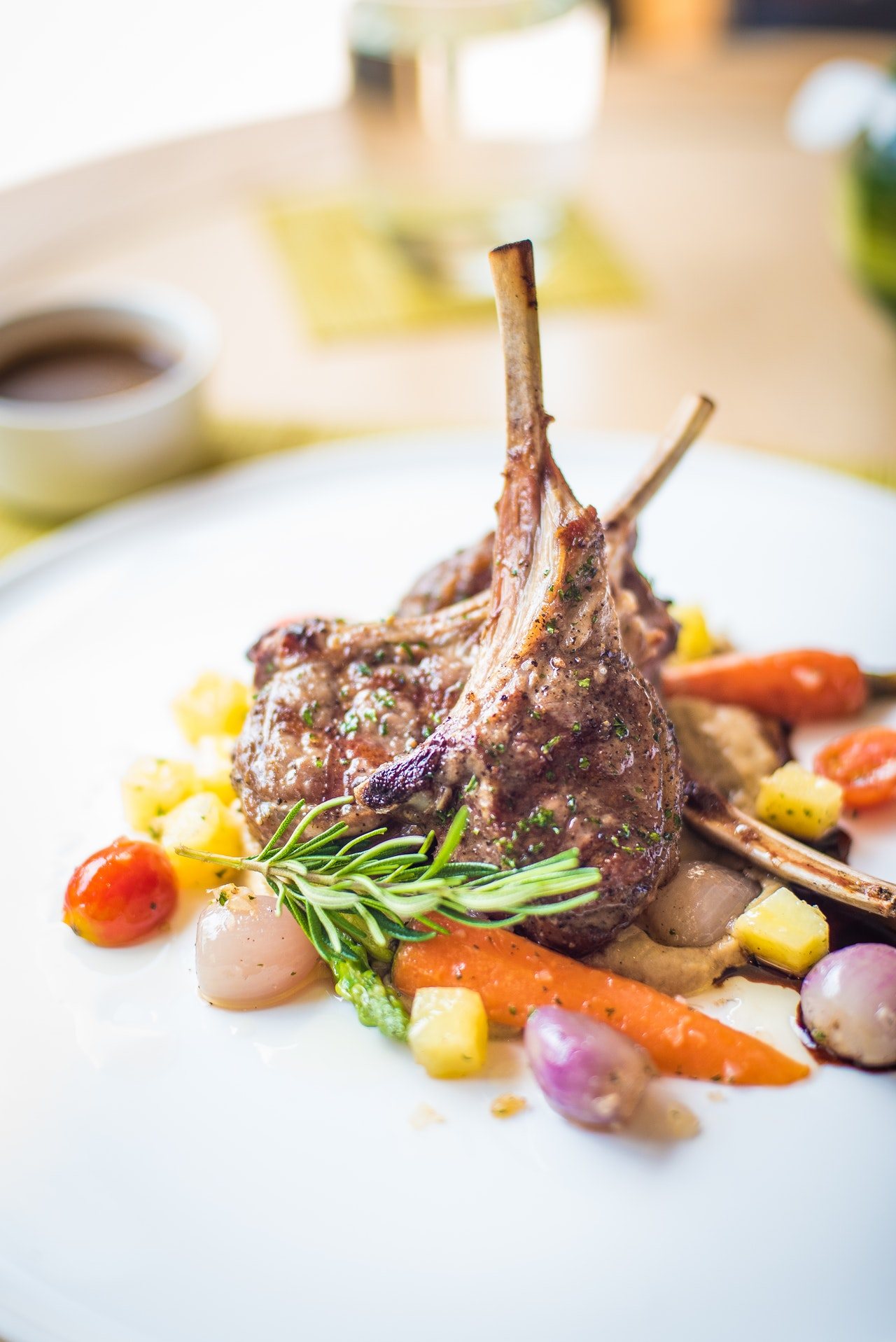 Plate of lamb chops with vegetables and garnish