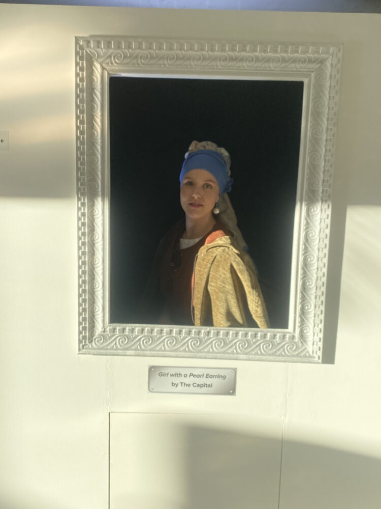 Art installation of a girl in a framed portrait