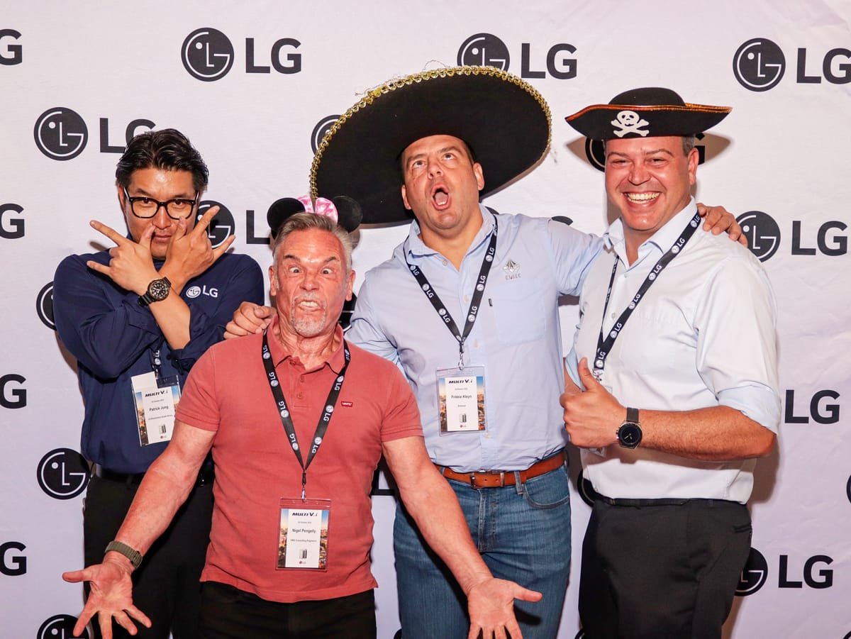 Four men in costumes posing at a corporate event photo booth