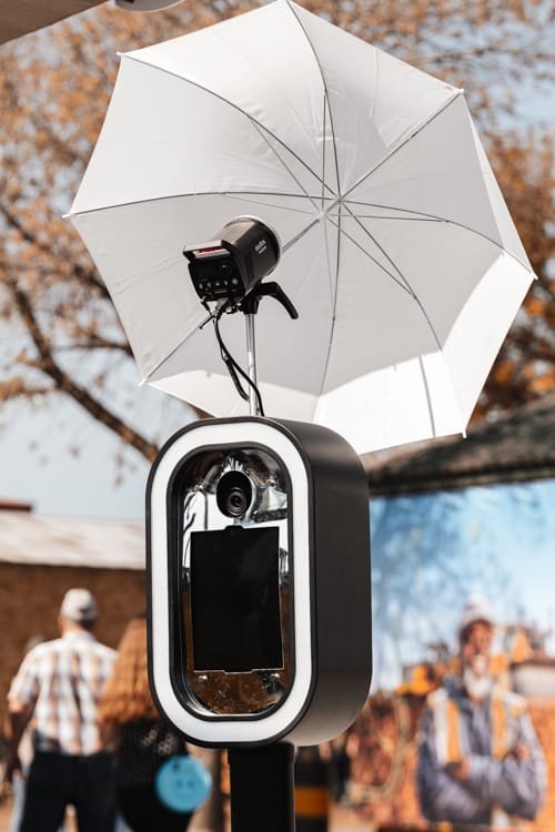 Selfie pod with an umbrella and camera setup