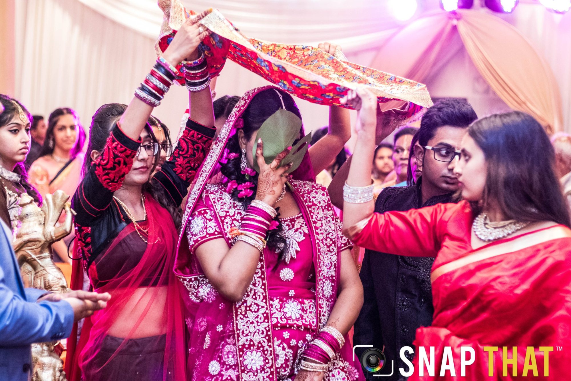 Guests participating in a cultural ceremony with traditional attire.