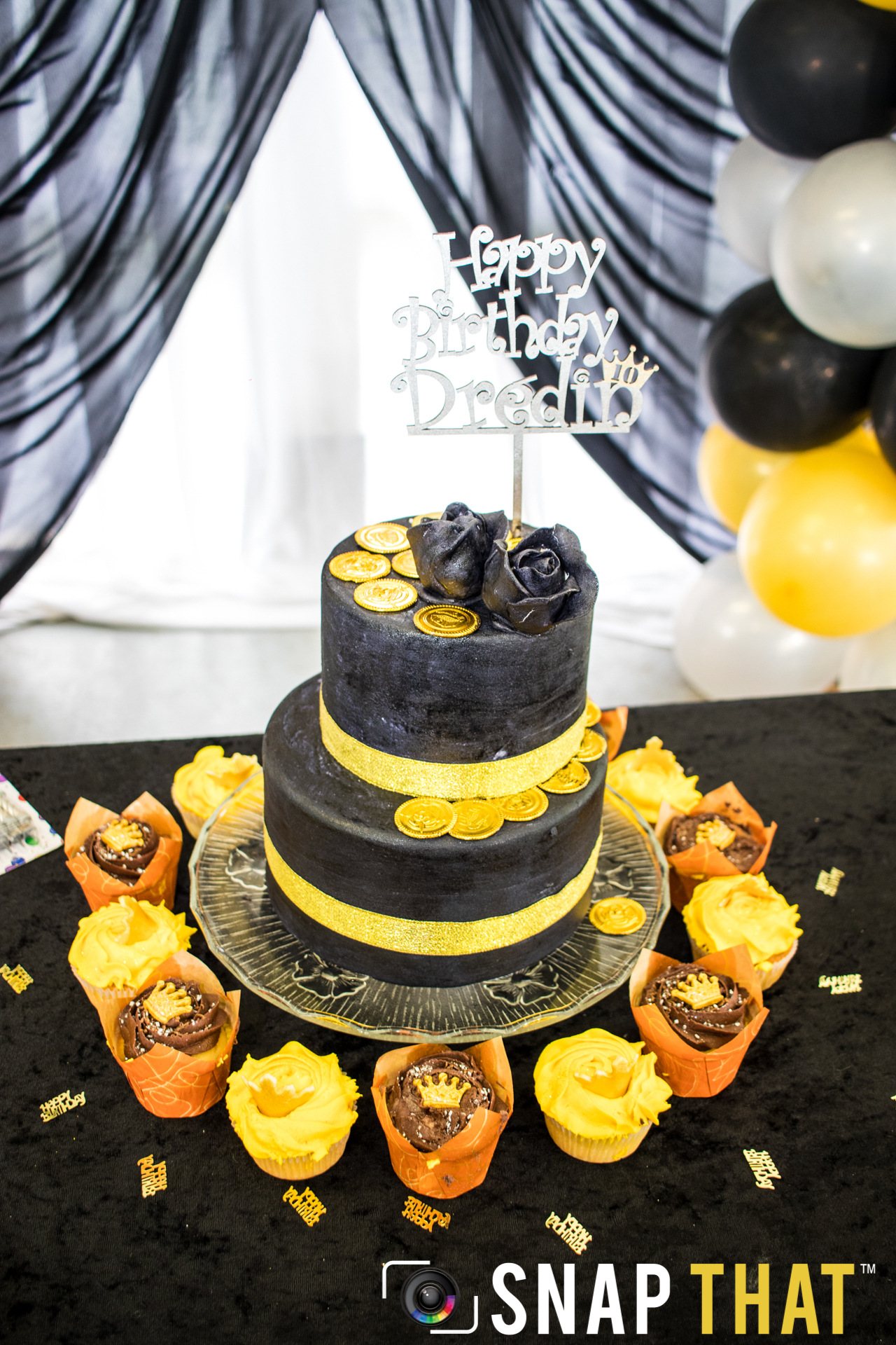 Two-tier birthday cake with roses and gold accents
