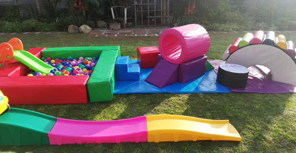 Colorful soft play equipment including a ball pond and slides