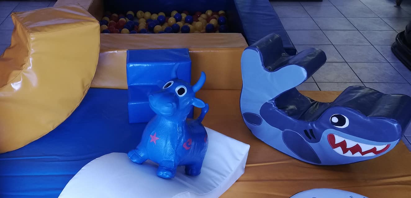 Colorful soft play equipment with a ball pond and themed toys