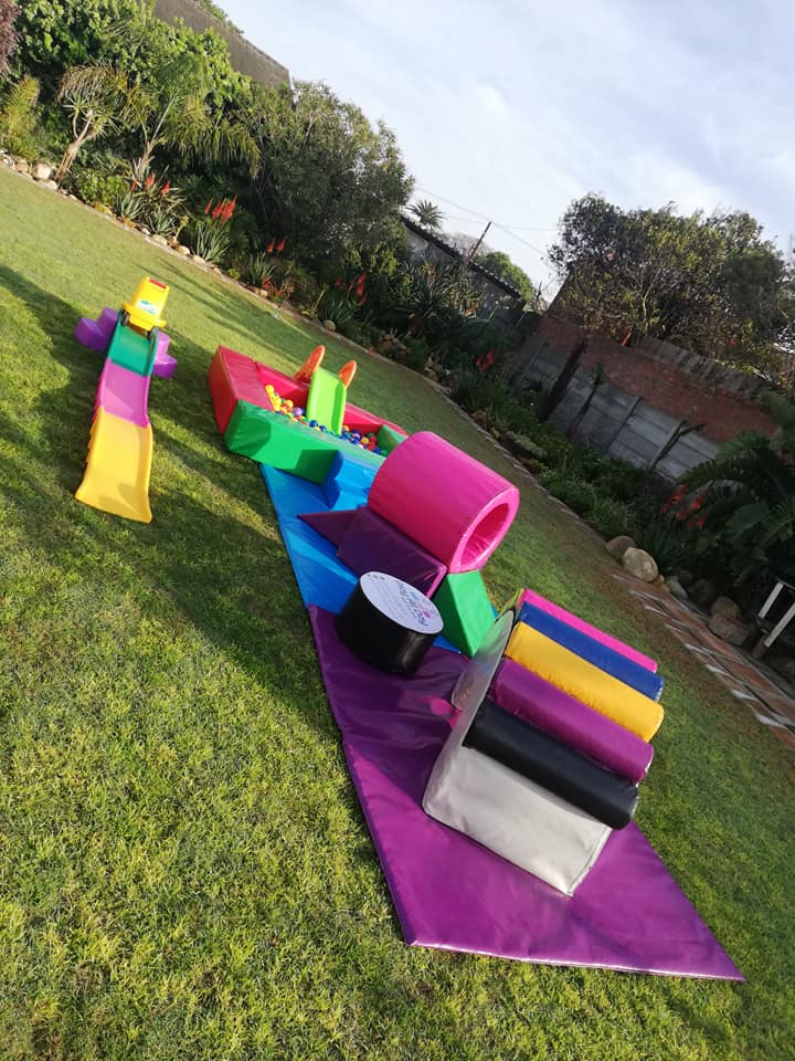 Colorful soft play equipment arranged on grass