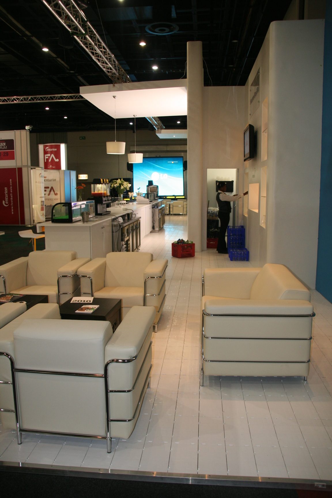 Contemporary exhibition flooring with lounge seating and display areas.