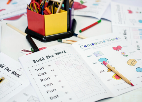Colorful workspace with design materials and invitation cards