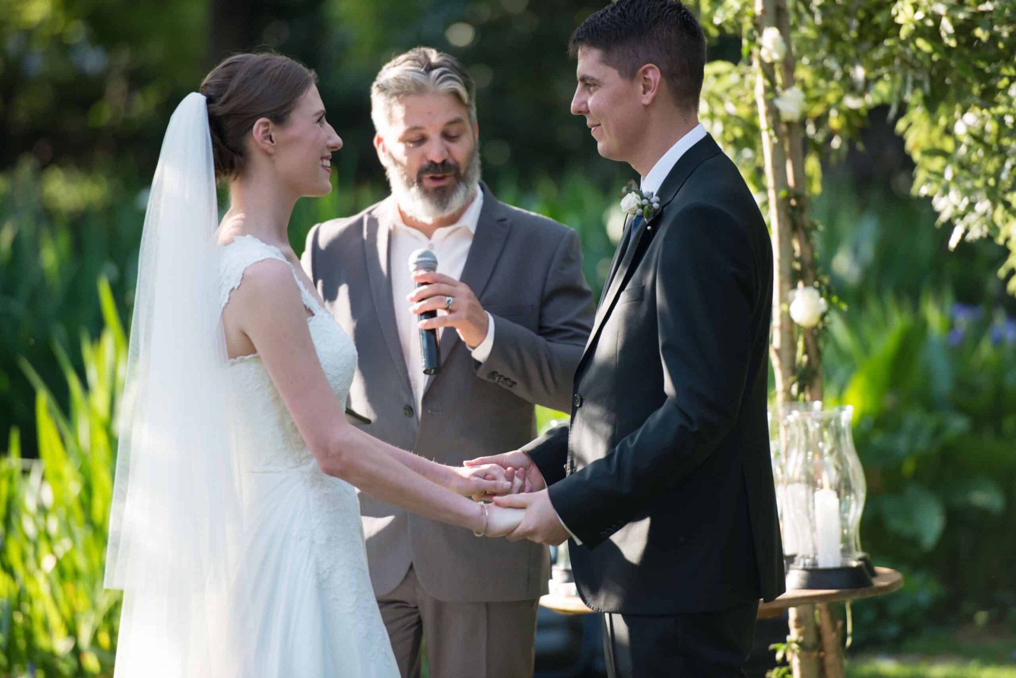 Couples exchanging vows during an outdoor wedding ceremony