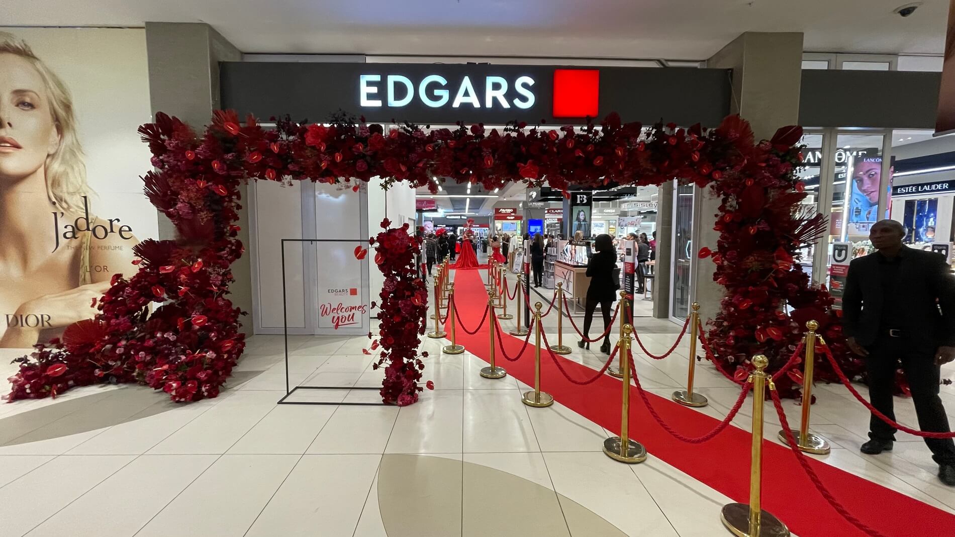Floral arch decoration at Edgars entrance with red flowers