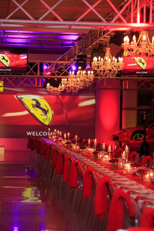 Corporate event with dramatic lighting and decorated long table