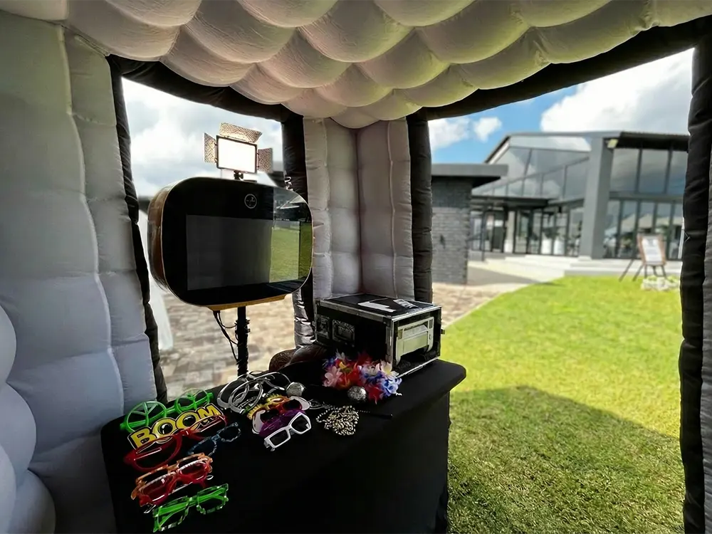 Interior of inflatable Party Booth with props and black photo booth.