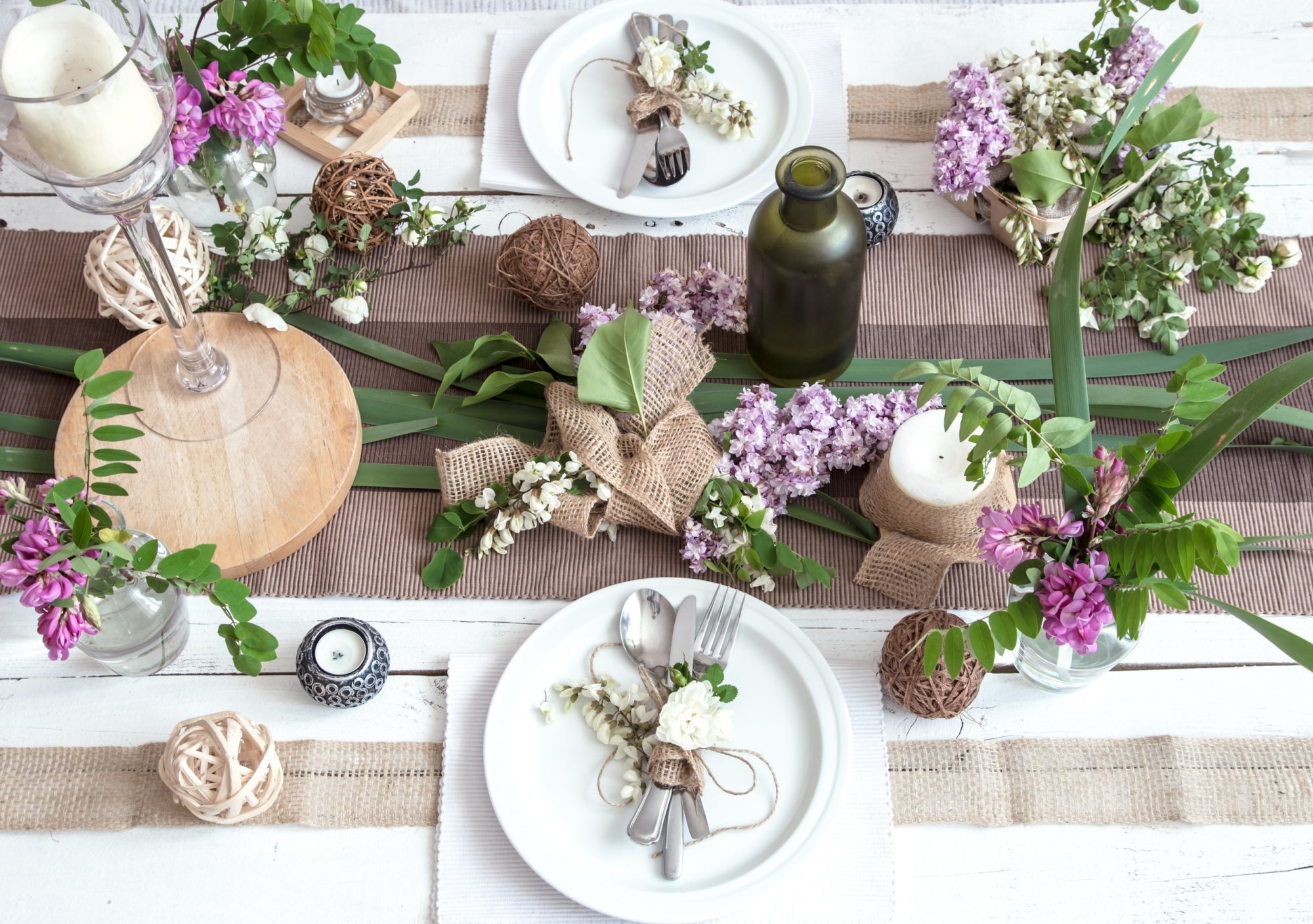 Decorated table with floral arrangements and tableware.