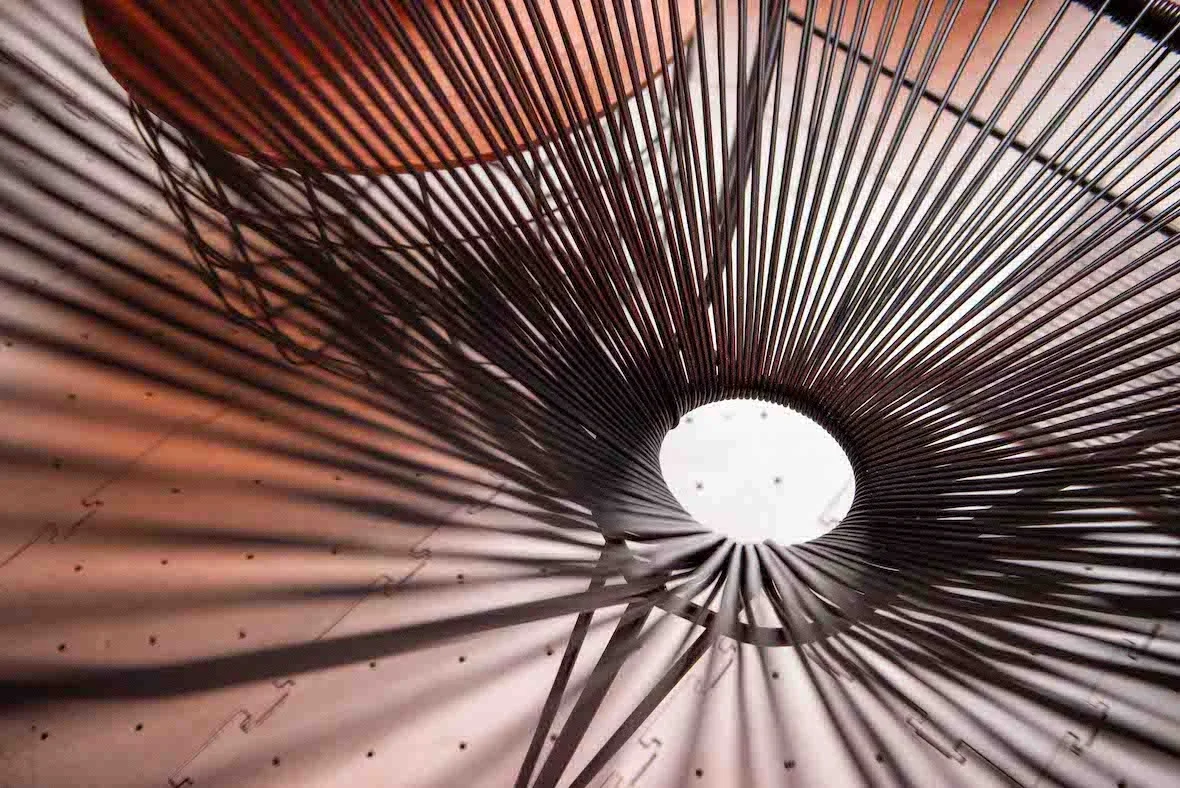 Wire cocktail table casting shadows on the surface.