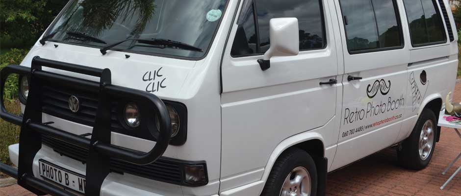 White VW Microbus with Retro Photo Booth branding