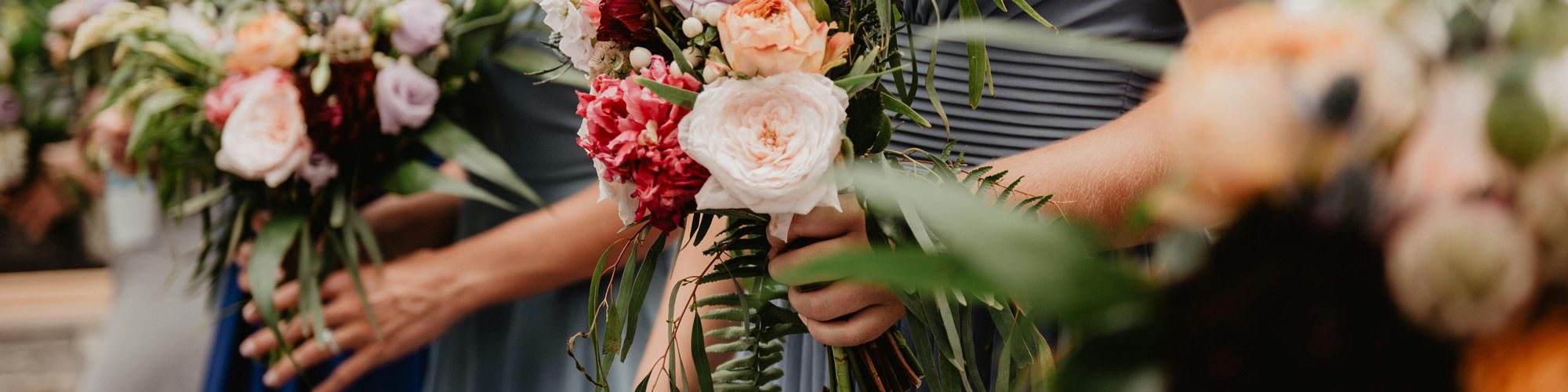 Colorful floral bouquets held by guests