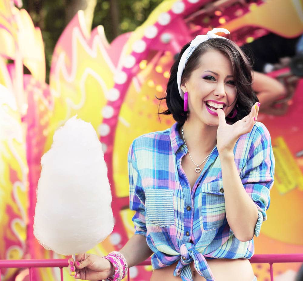 Person enjoying candy floss at an event