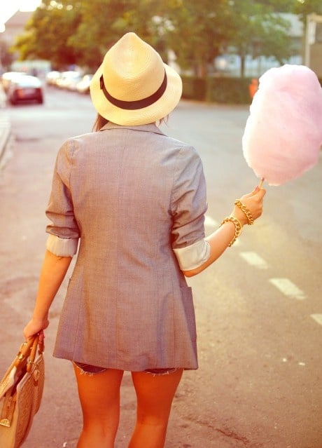Person holding candy floss while walking outdoors