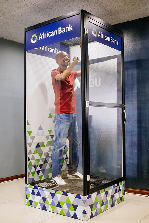 Dunk tank setup with a smiling participant inside
