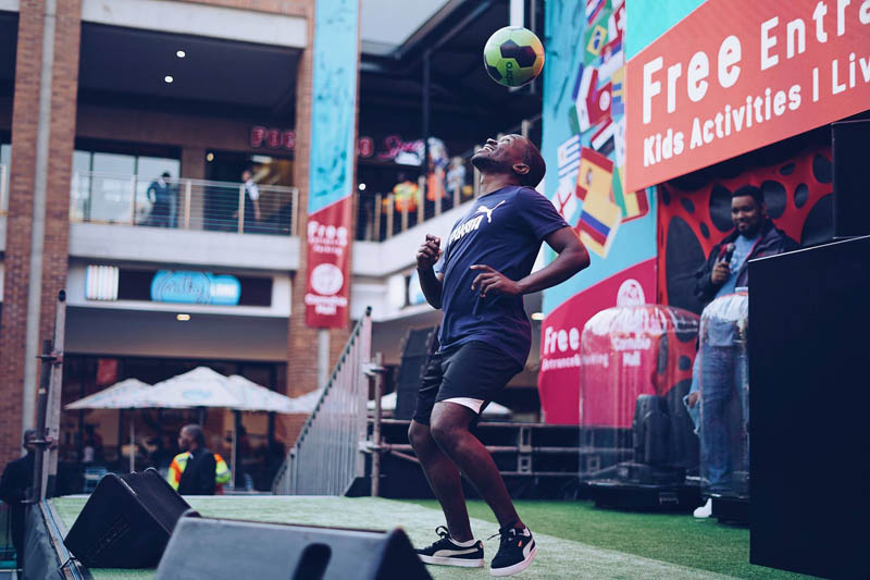 Person balancing a soccer ball during a live performance