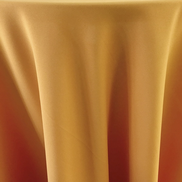 Golden fabric table runner draped elegantly over a table.
