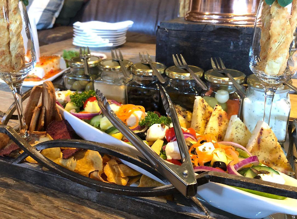 Gourmet platter featuring assorted vegetables, dips, and snacks.