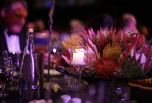 Floral centerpiece with a candle on a table setup