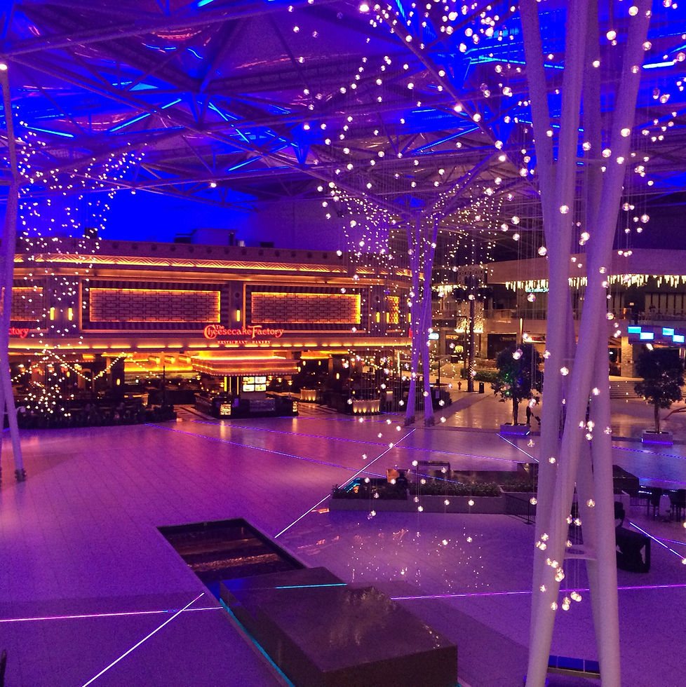 Illuminated event venue with modern architecture and decorative lights.