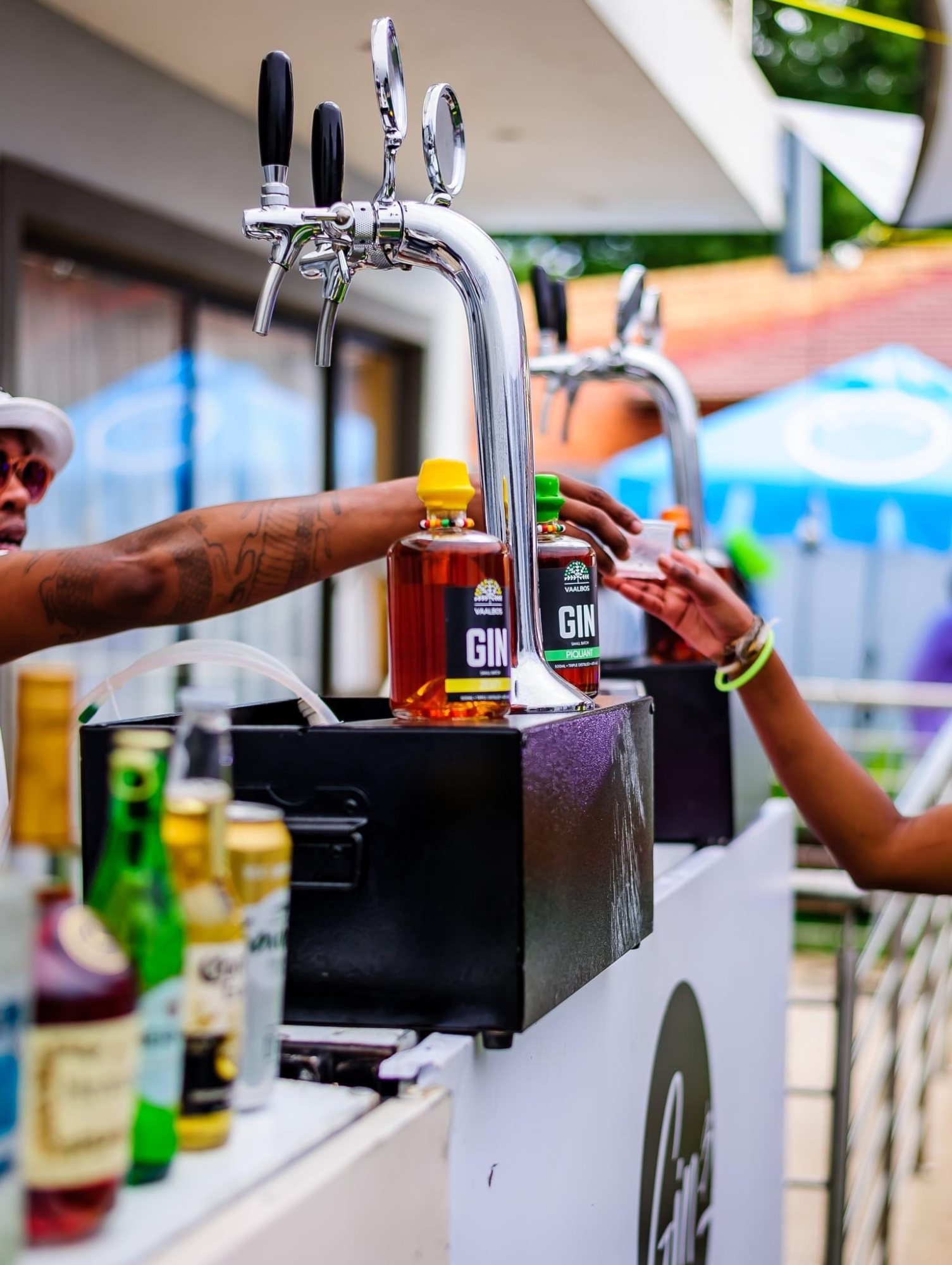 Mobile bar with gin taps and guests interacting