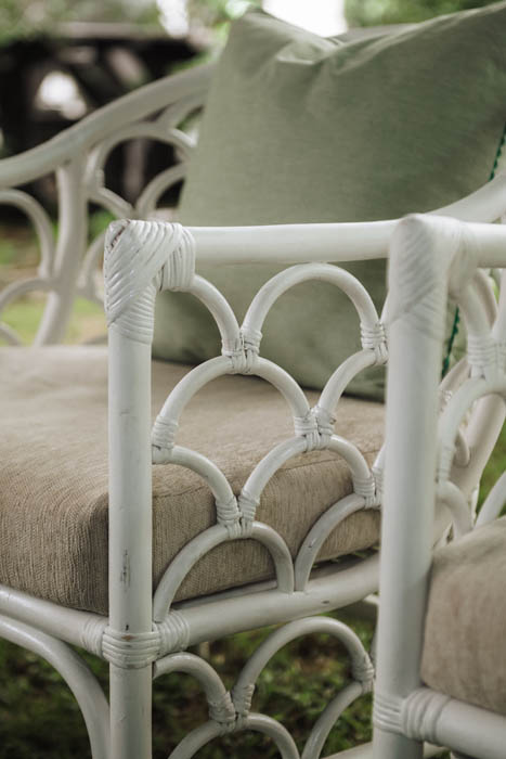 Close-up of a rattan lounge chair with a cushion