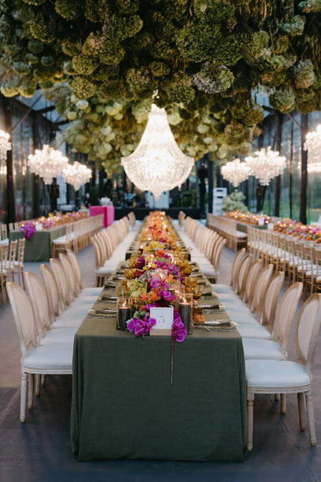 Long table decorated with flowers and chandeliers