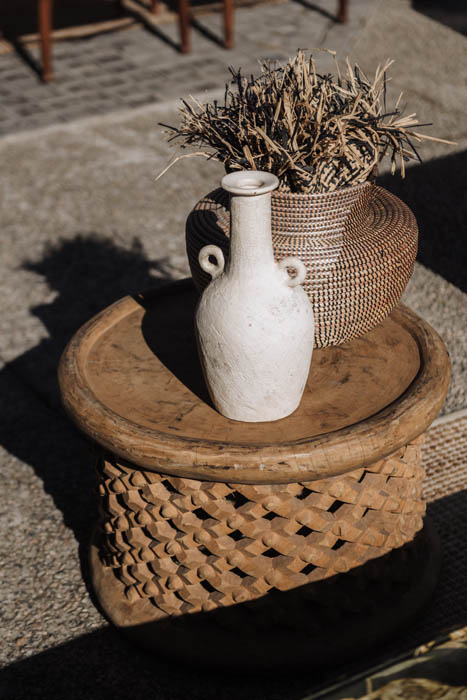 Decorative table setup with vase and woven basket.
