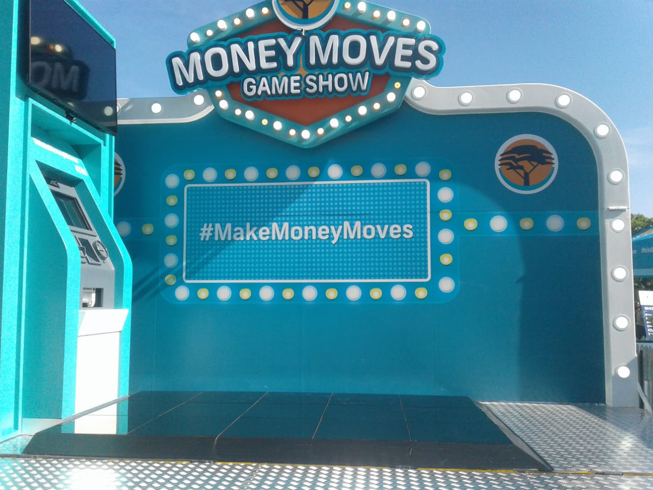 Backdrop for Money Moves game show with hashtag #MakeMoneyMoves