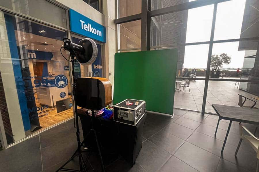 Green screen booth setup with equipment ready for use.