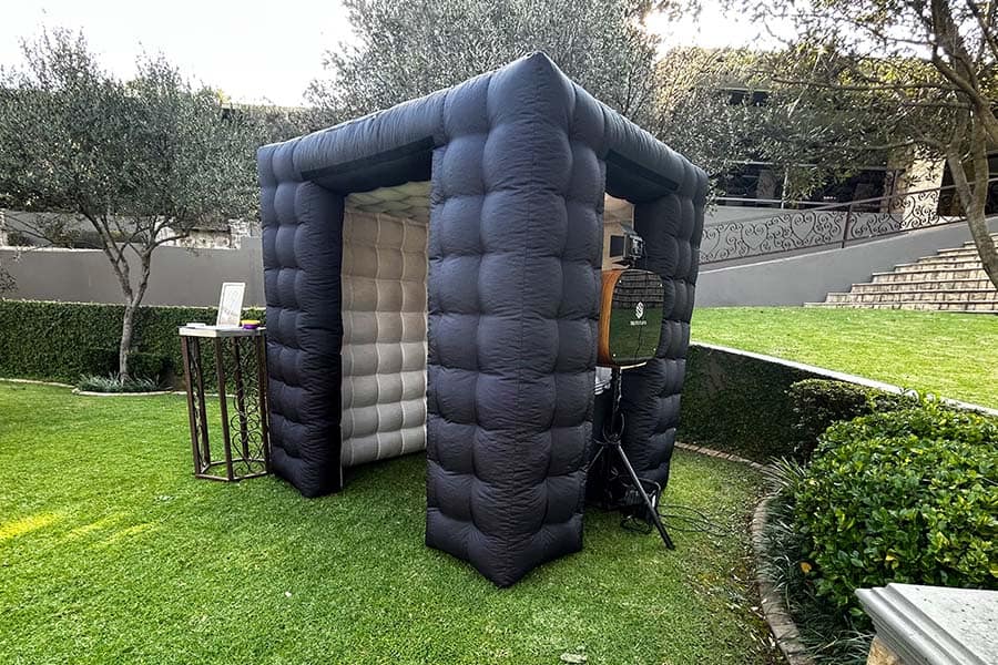 Inflatable photo booth set up in a garden.