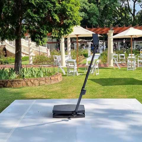 Vintage photo booth on a white platform in a garden