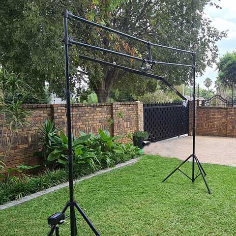 Black backdrop frame set up outdoors on grass