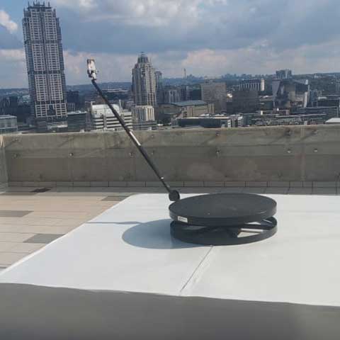 360 Spin Booth set up on a rooftop overlooking the city skyline.